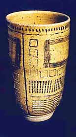 Wheel thrown stoneware tumbler with wide variety of texture tools used.