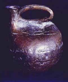 Hand built stoneware jug that looks like a primitive Scottish curling stone.
