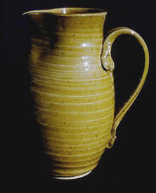 Tall stoneware pitcher with clear glaze.