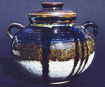 Stoneware jar with Tenmoku glaze and ring lugs that provide lift.